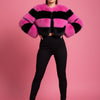 Pink and black striped fur jacket on a mannequin against a white background