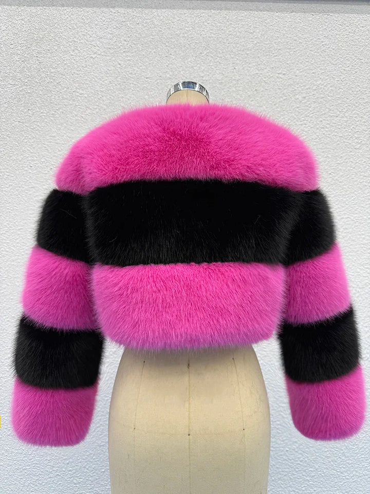 Pink and black striped fur coat on a mannequin against a light gray background