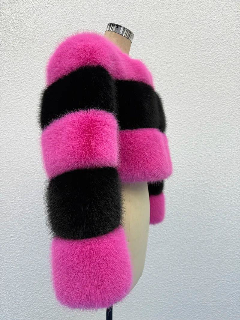 Mannequin wearing a pink and black fur stole against a white background