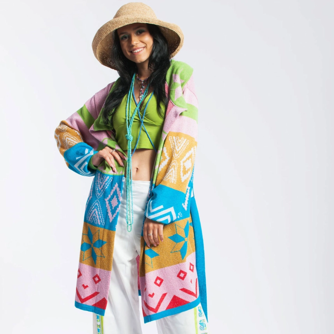 Woman wearing a colorful patterned kimono-style garment on a white background